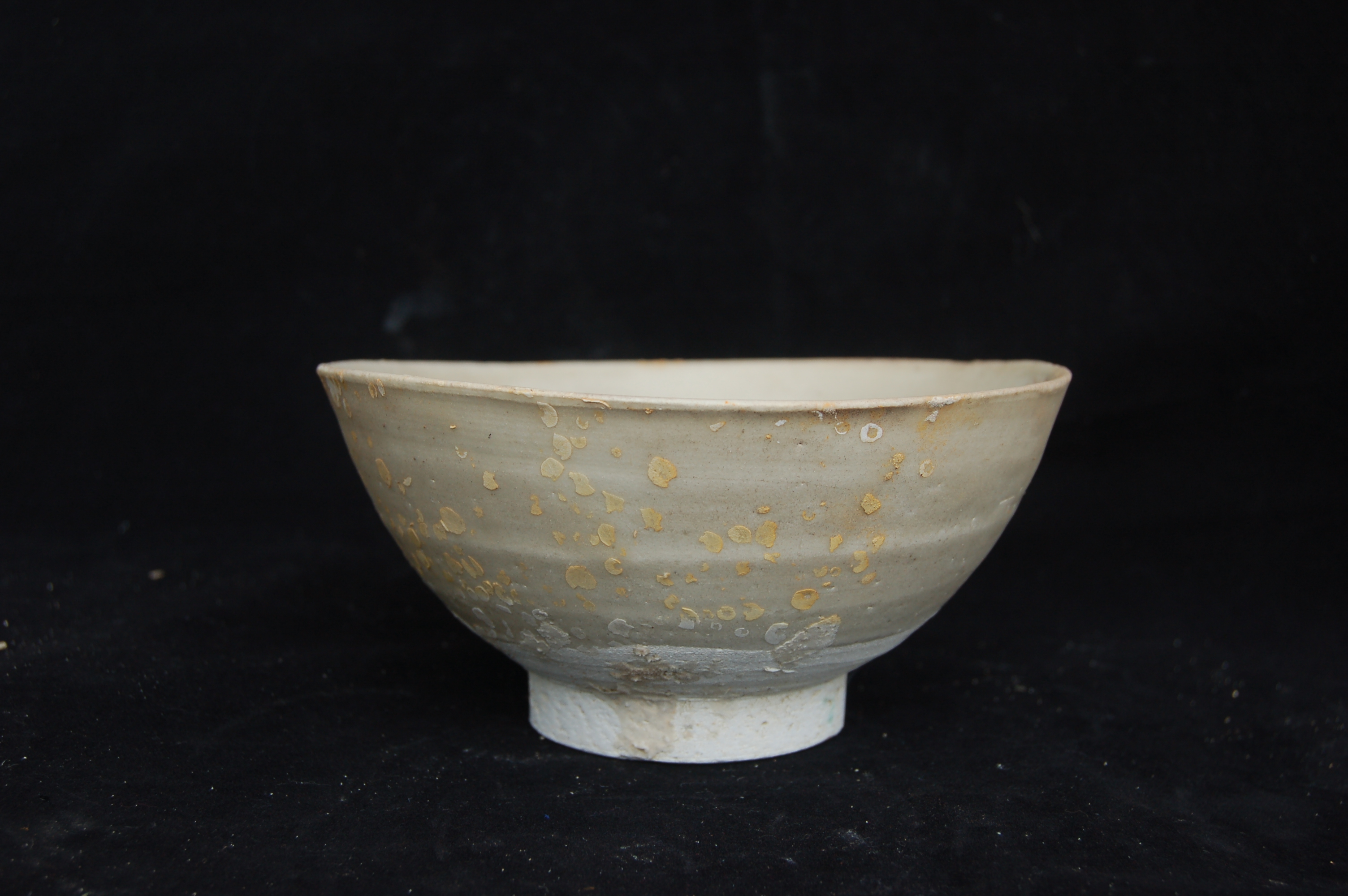 Plain bowl with a straight rim, incised ring in the well, rounded wall and a high carved foot-ring. Diameter 16 cm, height 7.5 cm.
