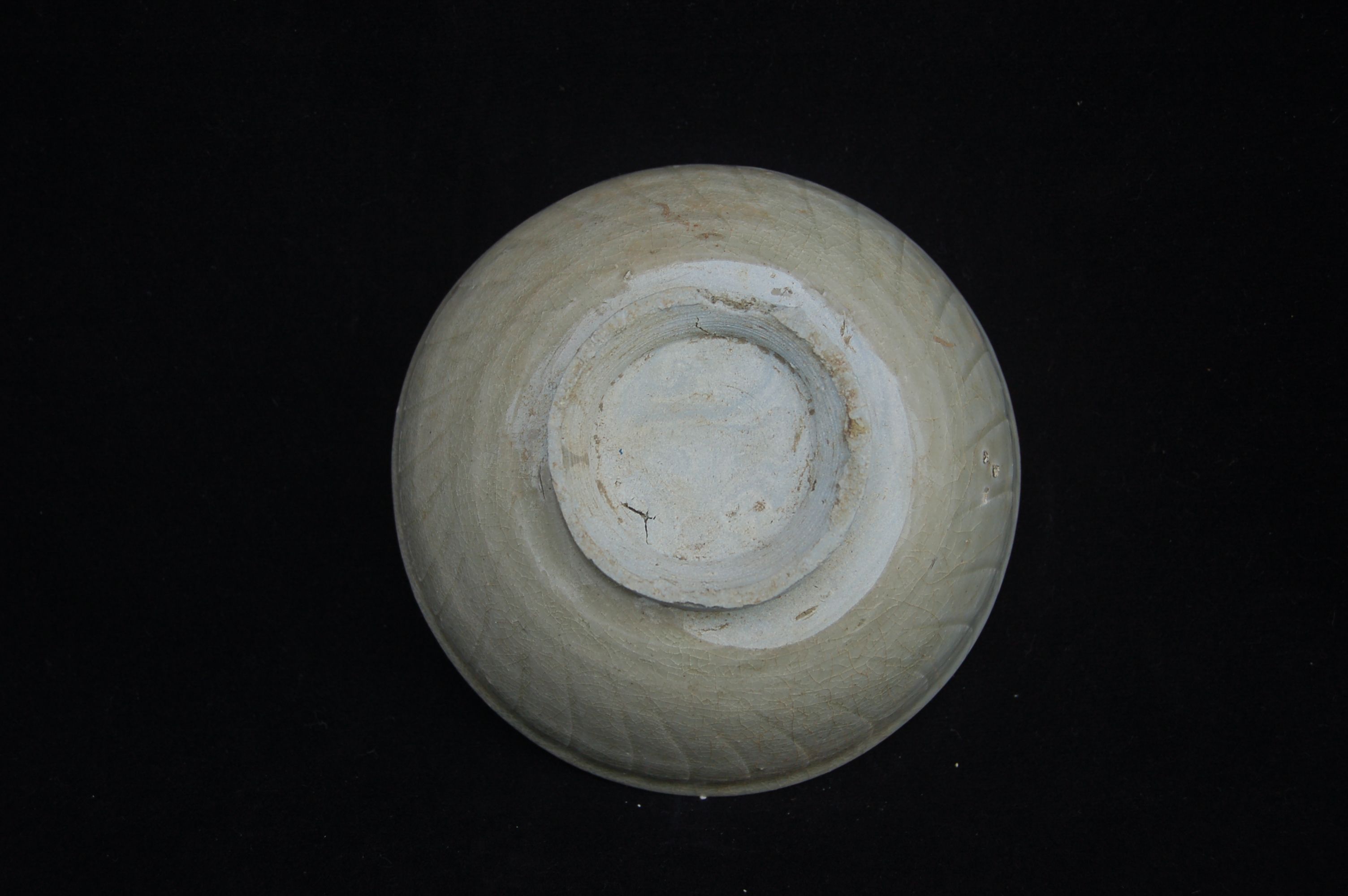 Small bowl with slightly everted rim, rounded wall with incised striations, on a high carved foot-ring. Diameter 12 cm, height 5 cm.