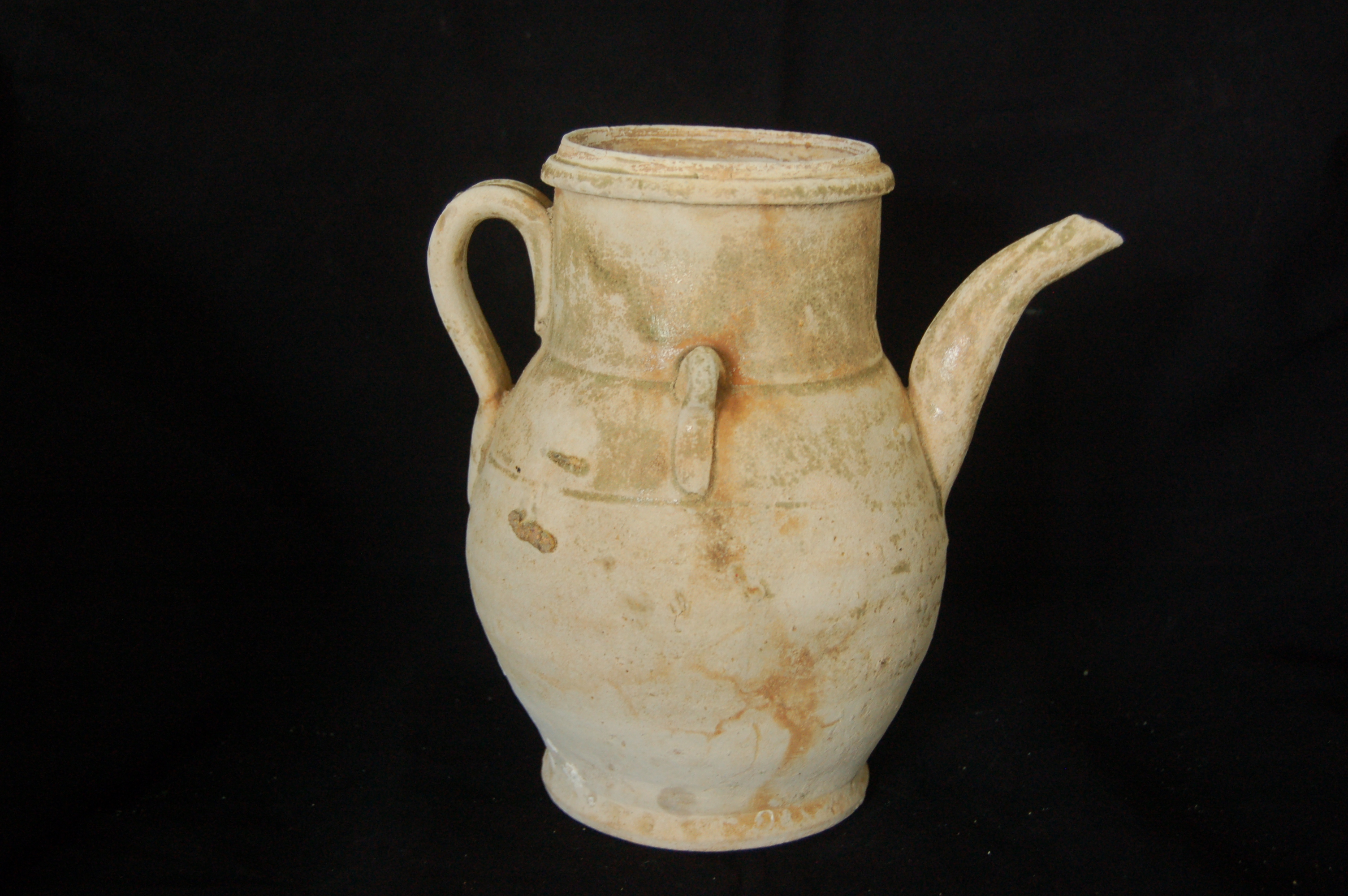 Ewer with a wide straight neck, flanged mouth-rim, curved spout and strap handle, with ear-handles high on the shoulder in between. The foot is flared with a flat base. Diameter 14 cm, height 19.5 cm.