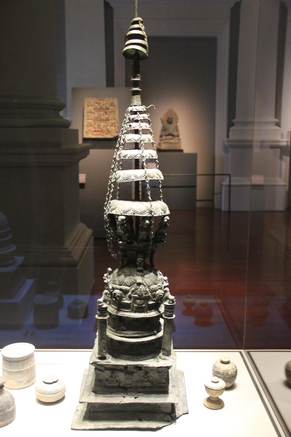 Stupa shaped bronze reliquary in showcase